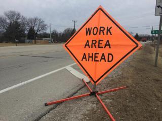 road work ahead sign on the side of the road